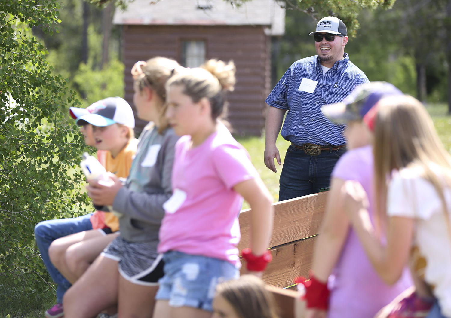 Bryce McKenzie laughs with a couple of kids as the group learns about why the sky is blue